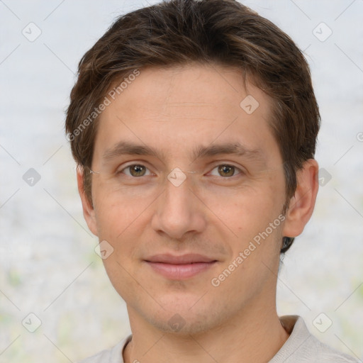 Joyful white young-adult male with short  brown hair and grey eyes