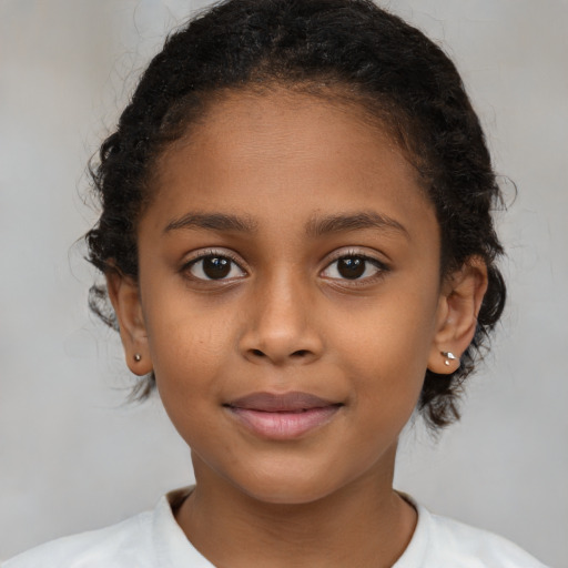 Joyful black child female with medium  brown hair and brown eyes