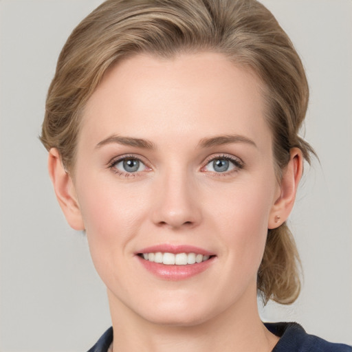 Joyful white young-adult female with medium  brown hair and blue eyes