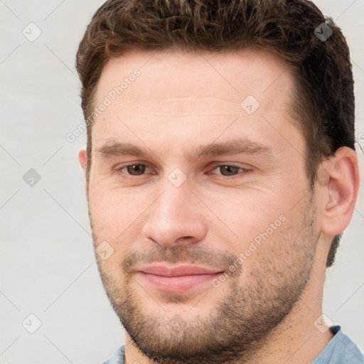 Joyful white young-adult male with short  brown hair and brown eyes