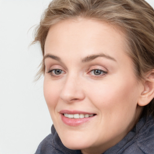 Joyful white young-adult female with medium  brown hair and blue eyes