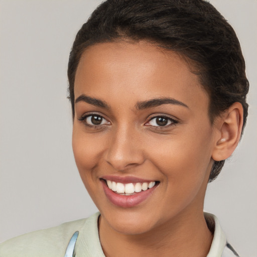 Joyful white young-adult female with short  brown hair and brown eyes