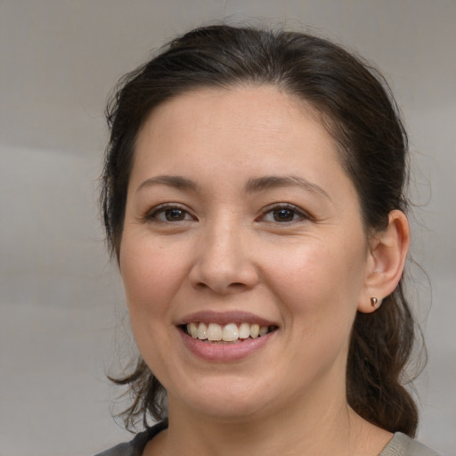 Joyful white young-adult female with medium  brown hair and brown eyes