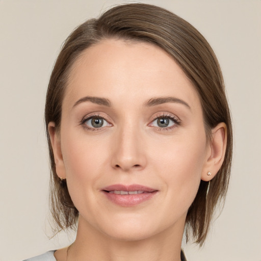 Joyful white young-adult female with medium  brown hair and grey eyes