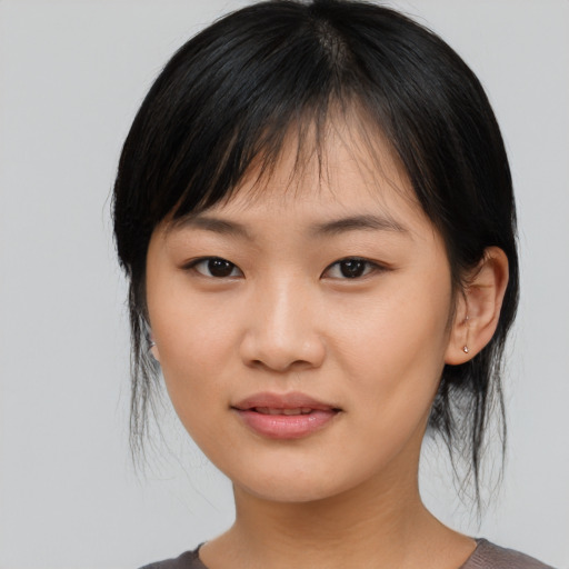 Joyful asian young-adult female with medium  black hair and brown eyes