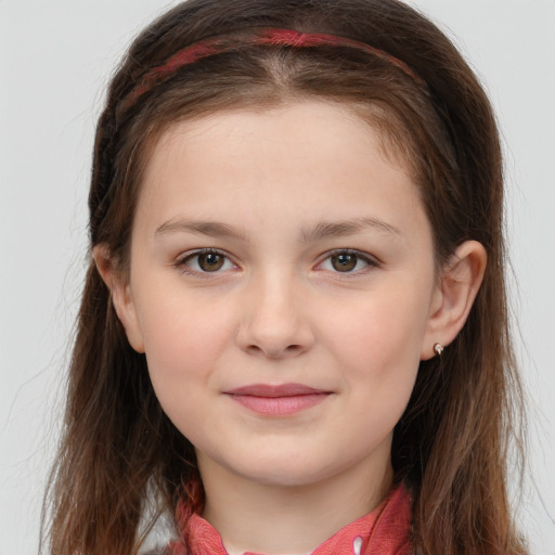 Joyful white child female with long  brown hair and brown eyes