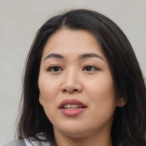 Joyful asian young-adult female with medium  black hair and brown eyes