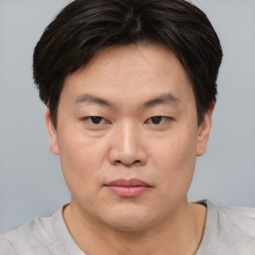 Neutral asian adult male with short  brown hair and brown eyes