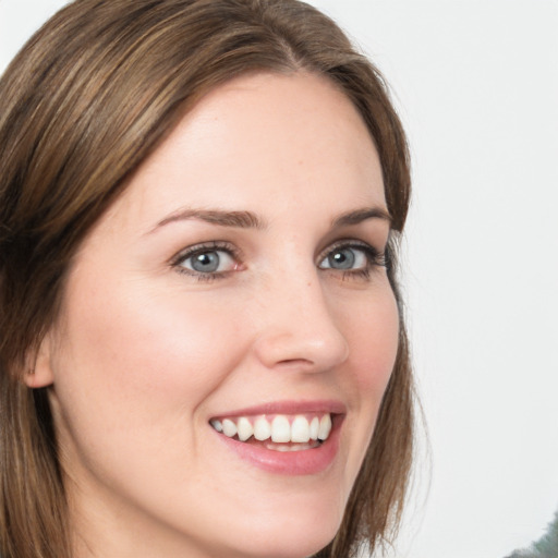 Joyful white young-adult female with long  brown hair and green eyes