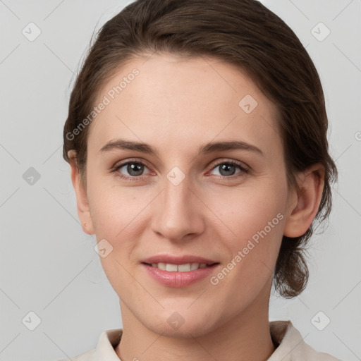 Joyful white young-adult female with medium  brown hair and grey eyes