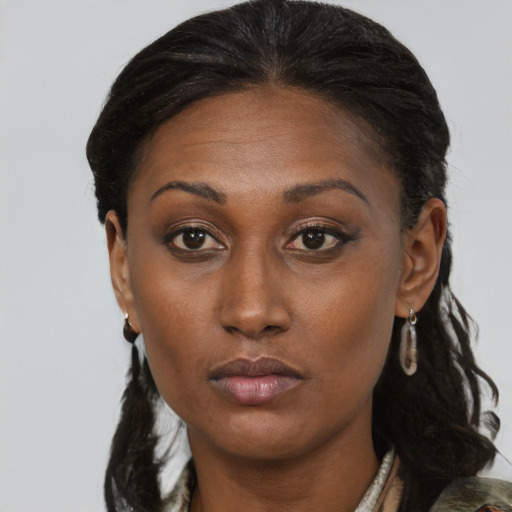 Neutral black young-adult female with medium  brown hair and brown eyes