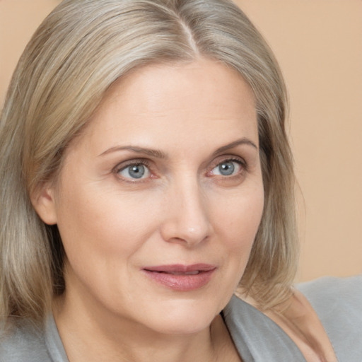 Joyful white young-adult female with medium  blond hair and brown eyes