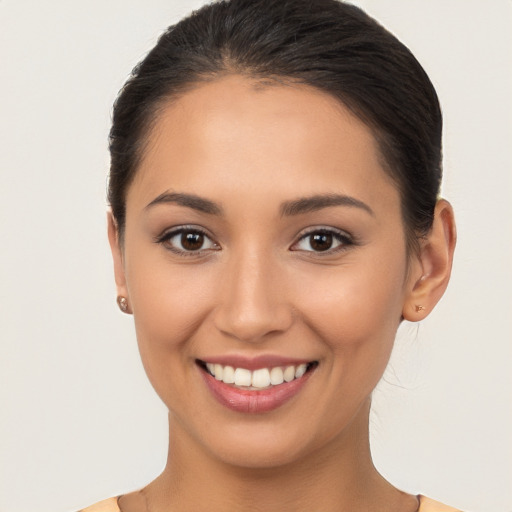 Joyful white young-adult female with long  brown hair and brown eyes