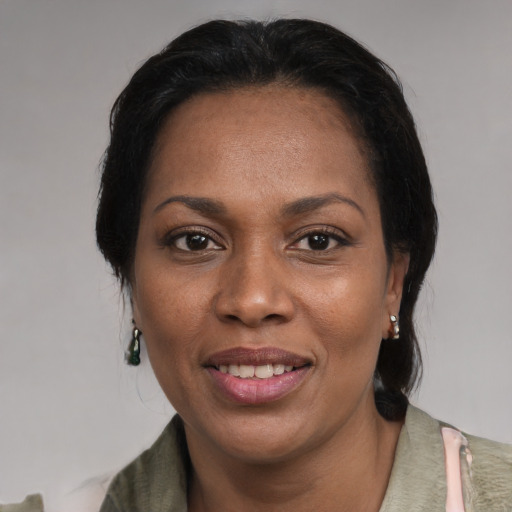 Joyful black adult female with medium  black hair and brown eyes