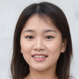 Joyful asian young-adult female with long  brown hair and brown eyes