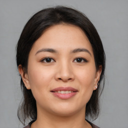 Joyful asian young-adult female with medium  brown hair and brown eyes