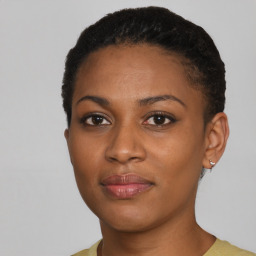 Joyful black young-adult female with short  black hair and brown eyes