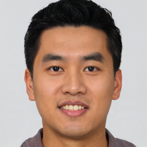 Joyful latino young-adult male with short  black hair and brown eyes