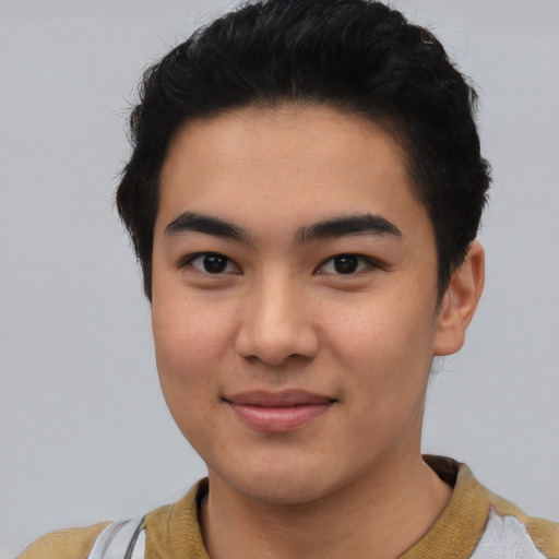 Joyful asian young-adult male with short  black hair and brown eyes