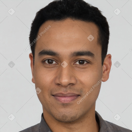 Joyful latino young-adult male with short  black hair and brown eyes