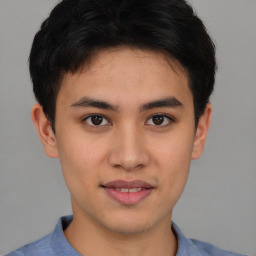 Joyful asian young-adult male with short  brown hair and brown eyes