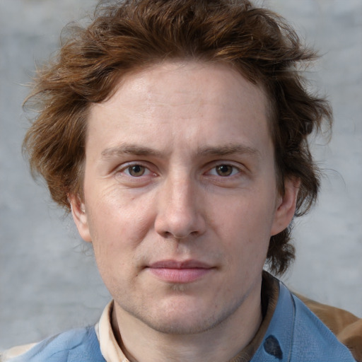 Joyful white adult male with short  brown hair and blue eyes