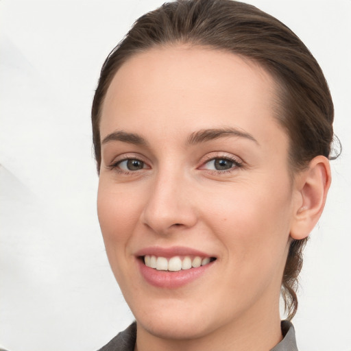 Joyful white young-adult female with short  brown hair and grey eyes