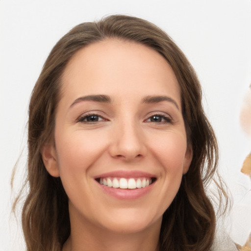 Joyful white young-adult female with long  brown hair and brown eyes