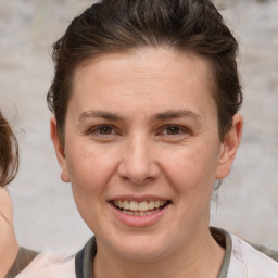 Joyful white adult female with short  brown hair and brown eyes