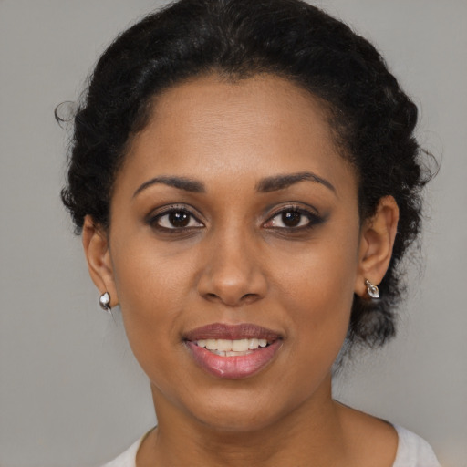 Joyful black young-adult female with short  brown hair and brown eyes