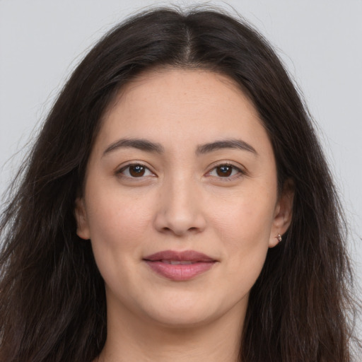 Joyful white young-adult female with long  brown hair and brown eyes