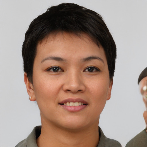 Joyful asian young-adult female with short  brown hair and brown eyes