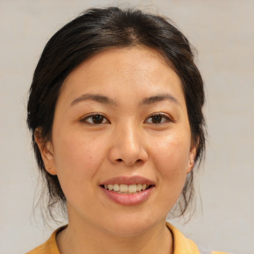 Joyful asian young-adult female with medium  brown hair and brown eyes