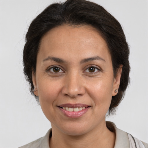 Joyful white adult female with medium  brown hair and brown eyes