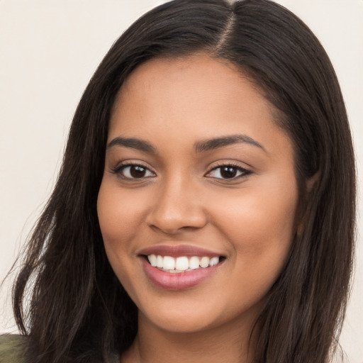 Joyful latino young-adult female with long  brown hair and brown eyes