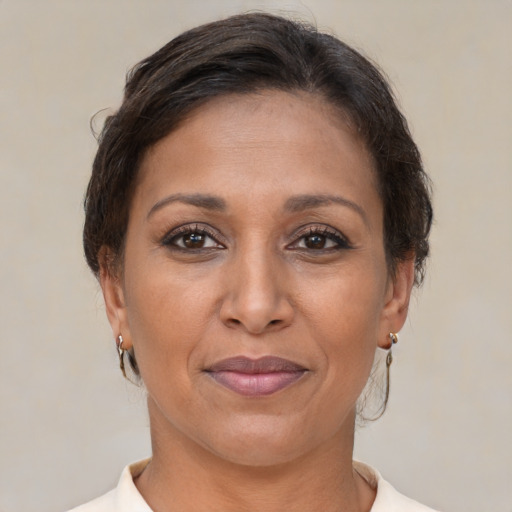 Joyful white adult female with short  brown hair and brown eyes