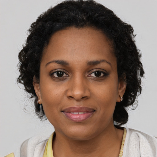 Joyful black young-adult female with short  brown hair and brown eyes