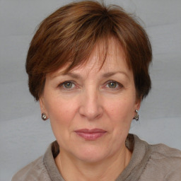 Joyful white adult female with medium  brown hair and grey eyes