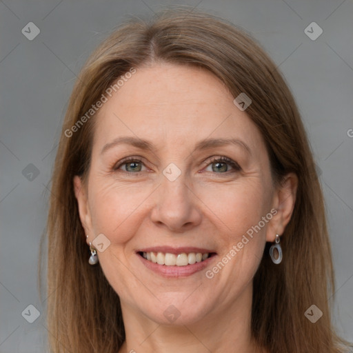 Joyful white adult female with long  brown hair and grey eyes