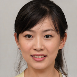 Joyful asian young-adult female with medium  brown hair and brown eyes