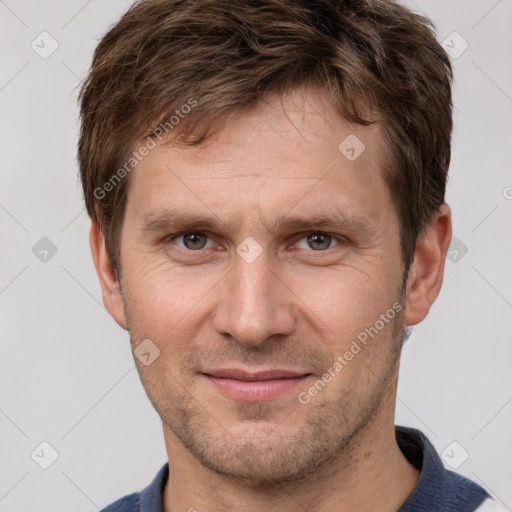 Joyful white adult male with short  brown hair and brown eyes