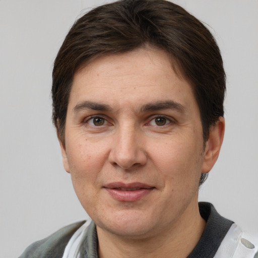 Joyful white adult female with short  brown hair and grey eyes