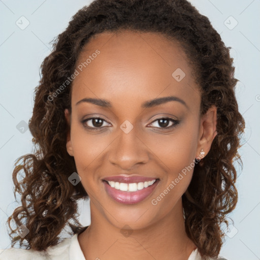 Joyful black young-adult female with long  brown hair and brown eyes