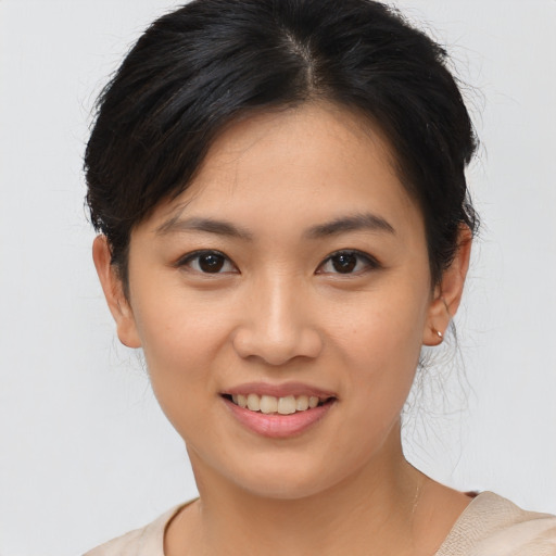 Joyful asian young-adult female with short  brown hair and brown eyes