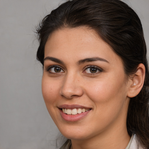 Joyful white young-adult female with medium  brown hair and brown eyes