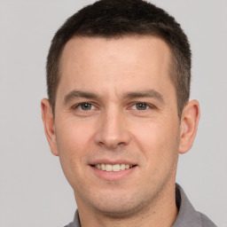 Joyful white young-adult male with short  brown hair and brown eyes