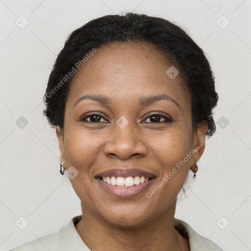 Joyful black young-adult female with short  brown hair and brown eyes