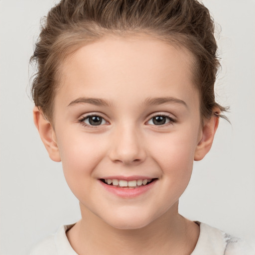 Joyful white child female with short  brown hair and brown eyes