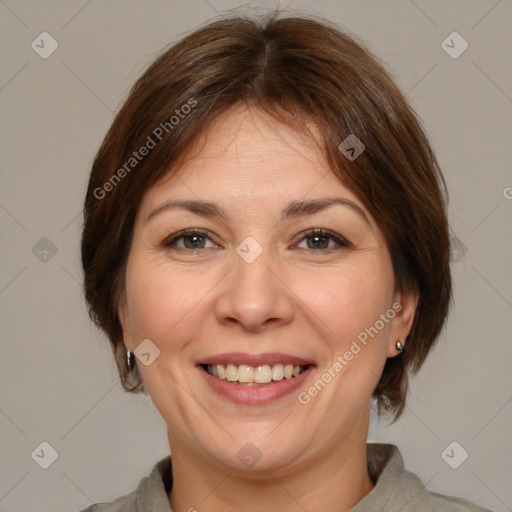 Joyful white adult female with medium  brown hair and brown eyes