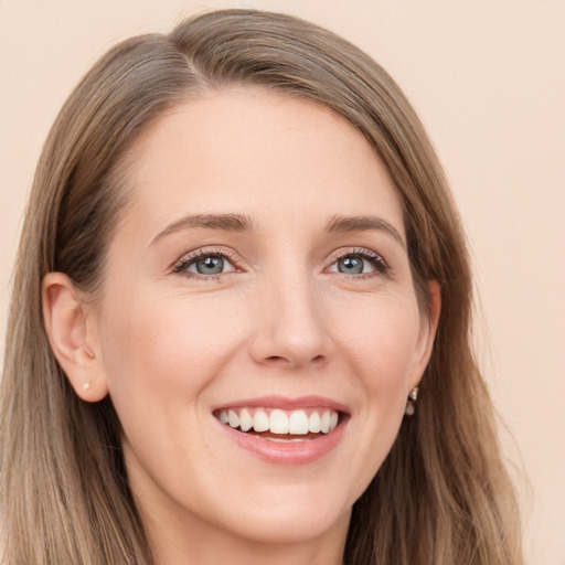 Joyful white young-adult female with long  brown hair and grey eyes